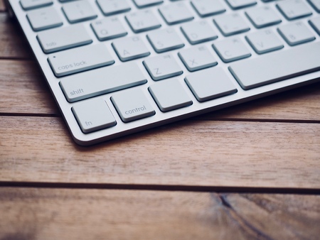 Wooden board with white keyboardの写真素材