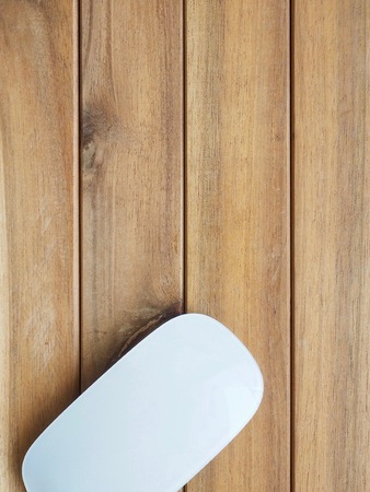 White computer mouse with wooden boardの写真素材