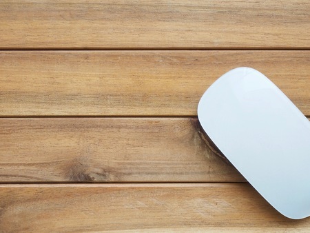 White computer mouse with wooden boardの写真素材