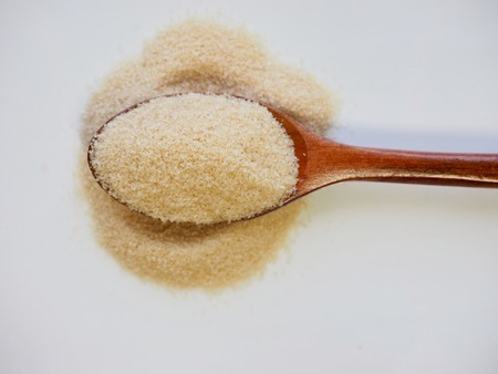 Brown powdered sugar in a spoonの写真素材