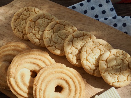 Butter cookies, chocolate cookies, coffee and maple leavesの写真素材