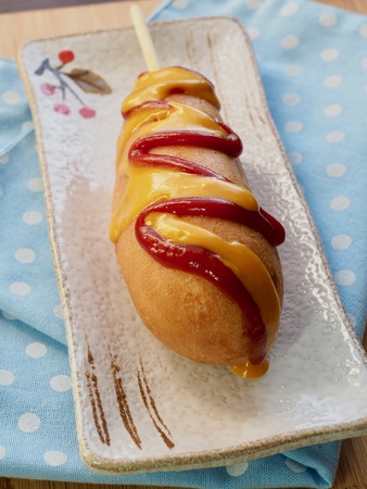 Ketchup and mustard sauce over hot dogsの写真素材