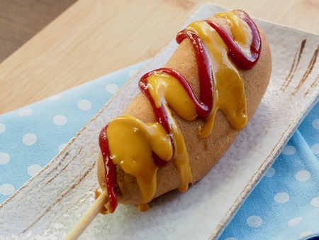 Ketchup and mustard sauce over hot dogsの写真素材