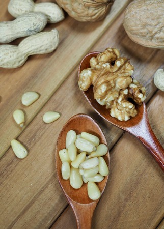 Walnuts and peanuts and pine nutsの写真素材