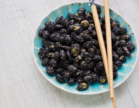 Black bean and black sesame stir-fried snack and chopsticksの写真素材