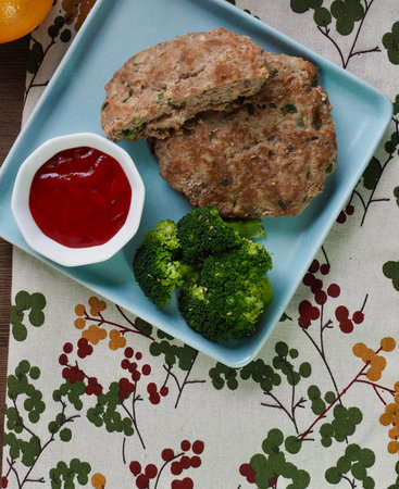 Hamburger steak, broccoli, ketchup and fruit