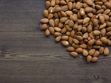 Wooden board and organic almonds, nutsの写真素材