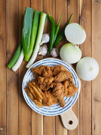 Fried chicken, French fries, Fresh organic vegetables, onion, wave, pepper, garlicの写真素材