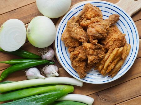 Fried chicken, French fries, Fresh organic vegetables, onion, wave, pepper, garlicの写真素材