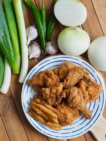 Fried chicken, French fries, Fresh organic vegetables, onion, wave, pepper, garlicの写真素材