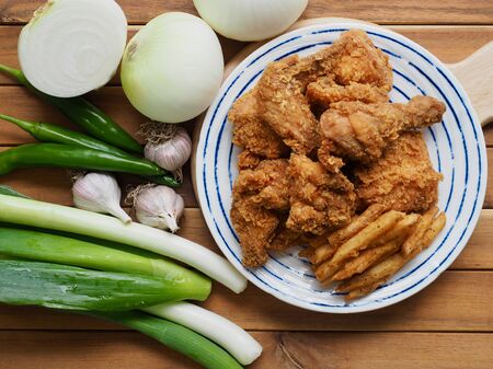 Fried chicken, French fries, Fresh organic vegetables, onion, wave, pepper, garlicの写真素材