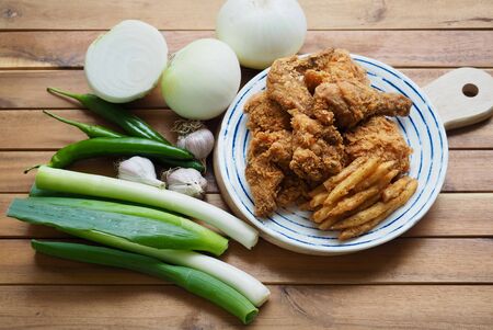 Fried chicken, French fries, Fresh organic vegetables, onion, wave, pepper, garlicの写真素材