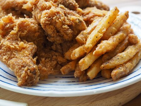 Fried chicken, French fries, Fresh organic vegetables, onion, wave, pepper, garlicの写真素材