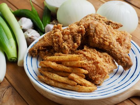 Fried chicken, French fries, Fresh organic vegetables, onion, wave, pepper, garlicの写真素材
