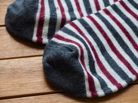Wood board background with striped socks, autumn socksの写真素材