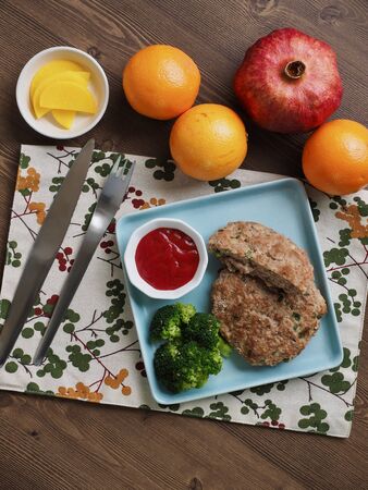 Hamburger steak, broccoli, ketchup and fruitの写真素材