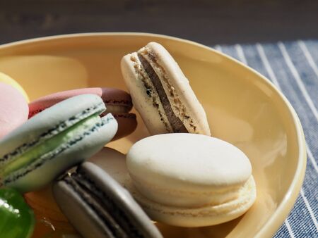 Red, yellow, green circle shaped candy and macaroonsの写真素材