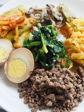 Korean side dishes, egg, beef, cucumber, mushroom, spinach, potatoの写真素材