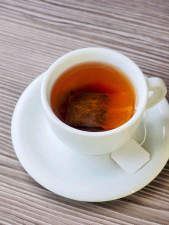 Tea on wooden boards and porcelain cups, black teaの写真素材