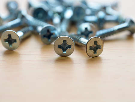 Wooden board background with silver screwsの写真素材