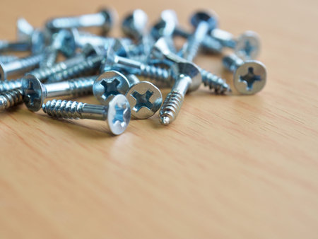 Wooden board background with silver screws