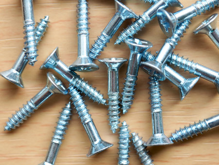 Wooden board background with silver screws