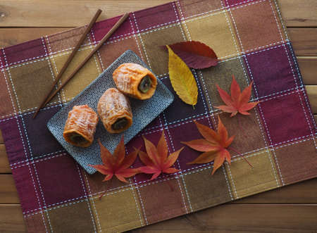 Korean traditional food, dried persimmon and Maple leafの写真素材