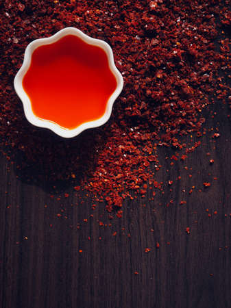 Red chilli oil in white porcelain bowl, rad pepper oilの写真素材