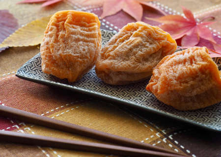 Korean traditional food, dried persimmon and Maple leafの写真素材