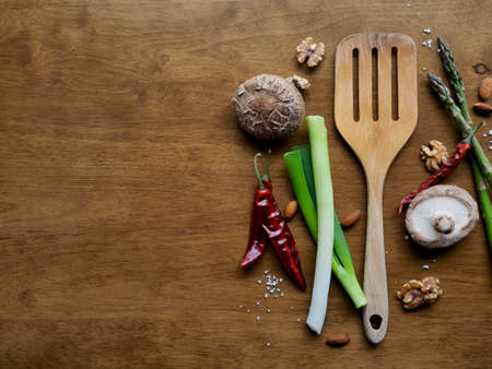 Cookware made of wood, Walnut, asparagus, salt, red pepper, green onion, mushroomの写真素材
