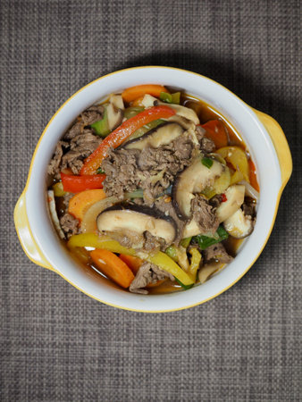 Beef and vegetables stewed in a bowl on a gray backgroundの写真素材