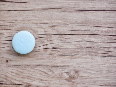 Blue macaroon on wooden background, top view with copy spaceの写真素材