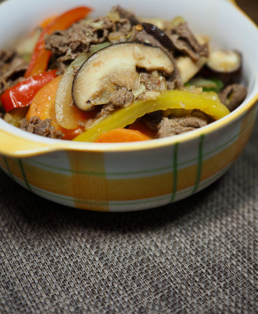 Beef stir fry with eggplant and bell pepper in a bowlの写真素材