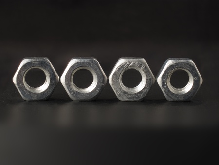 Four nuts in a row on a black backgroundの写真素材