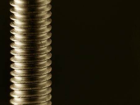 A screw-on a screw on a black backgroundの写真素材
