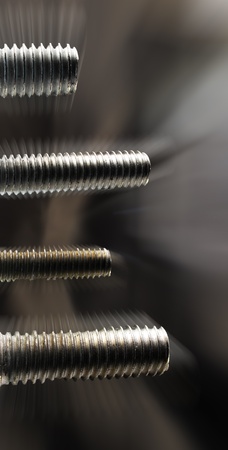 Four screws of different sizes with movement in verticalの写真素材