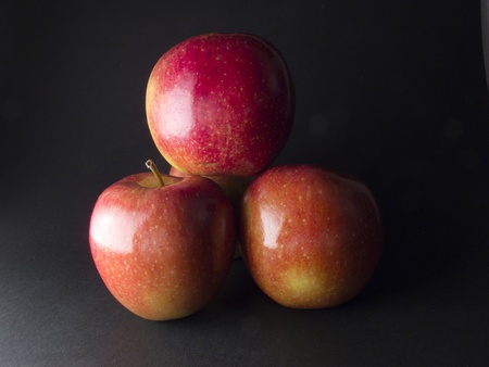 four red apples and fresh on a black backgroundの写真素材