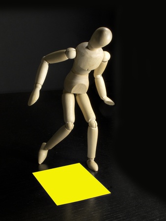 humanoid with a yellow sign on the floor by his feetの写真素材
