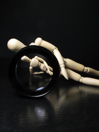 humanoid lying posing in front of a camera lensの写真素材