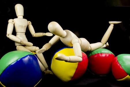 a humanoid couple playing with brightly colored ballsの写真素材