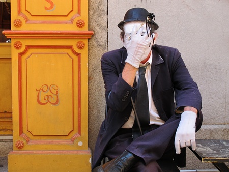 mime face covered with a mask and sittingの写真素材