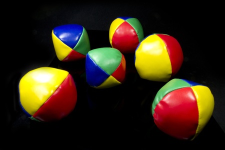 a juggling balls in bright colors on black backgroundの写真素材