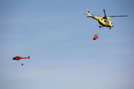 fire fighting helicopters fire on the mountainの写真素材