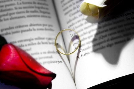 gold ring and book a romantic heart formingの写真素材