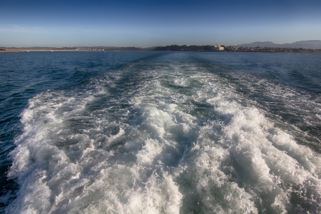 waves formed by the engine of a ship at seaの写真素材