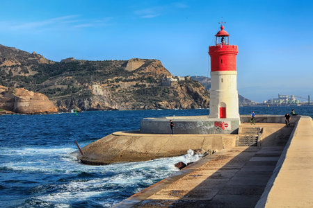red and white lighthouse at the port of Cartagena, Spainのeditorial素材
