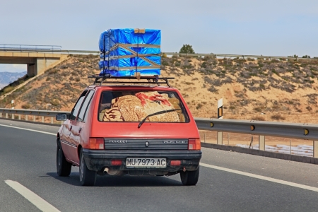 Madrid - Mar 22: 
car loaded with packages circulating during the holidays on the highway
 on Mar 22, 2013 in Madrid Spainのeditorial素材