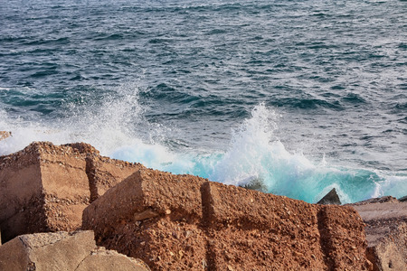 Large waves crashing and splashing on a seawallの写真素材