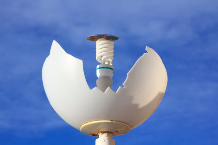broken by vandalism lamp with energy saving light bulb