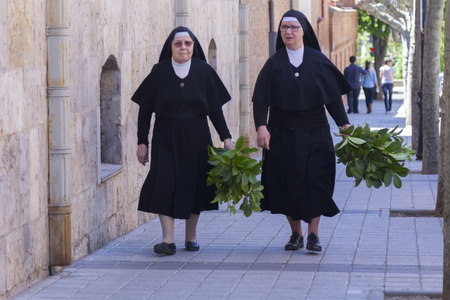MADRID,SPAIN - APRIL 4 Nuns walking down the street prepared the Feast of Palm Sunday April 4, 2014 in Madrid Spainのeditorial素材